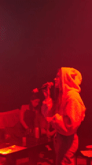 Woman performs in red-lit venue in Baan Bang Rak