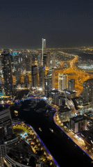 Aerial nighttime views of illuminated Dubai Marina captured