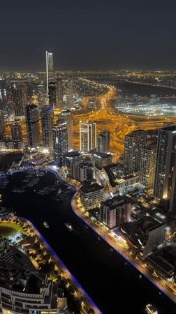 Aerial nighttime views of illuminated Dubai Marina captured