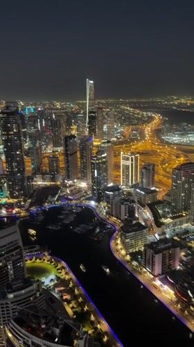 Aerial nighttime views of illuminated Dubai Marina captured