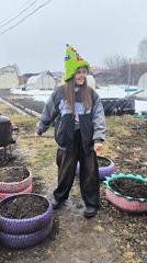Girl and charcoal grill spotted in muddy Elovo yard