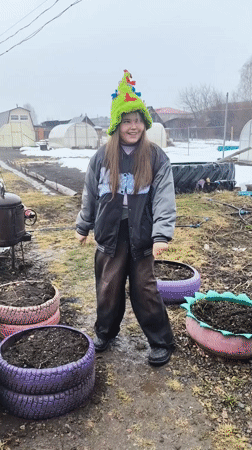 Girl and charcoal grill spotted in muddy Elovo yard