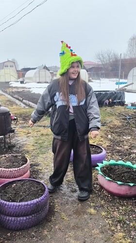 Girl and charcoal grill spotted in muddy Elovo yard