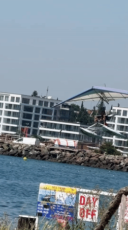 Float-equipped trike glider carries two people over open water