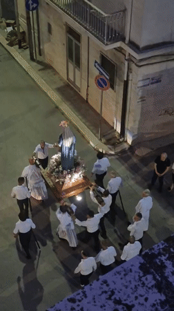 Religious procession with Virgin Mary statue through Barletta streets