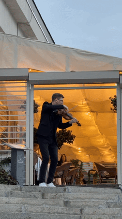 Street violinist performs on steps in Nizhny Novgorod