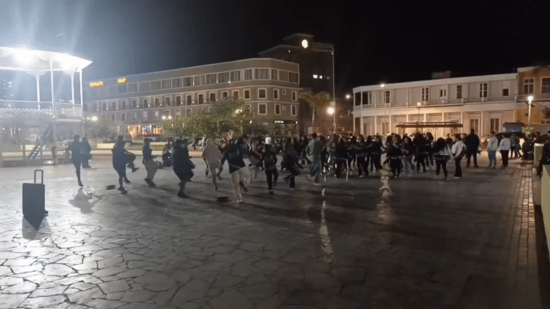 Group exercise session held in Iquique plaza at midnight