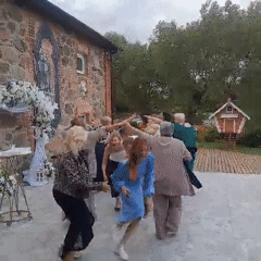 Outdoor circle dancing at a decorated rural Belarus celebration