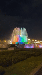 Evening documentation captures illuminated VDNKh pavilions and rainbow fountains