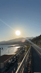 Cyclist documents sunny afternoon ride along Sanremo coastal path