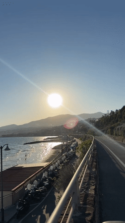 Cyclist documents sunny afternoon ride along Sanremo coastal path