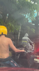 Shirtless motorcyclist spotted on North Kuta street