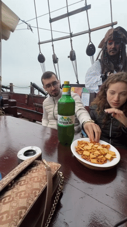 Pirate-themed ship with costumed performer docks at Varna harbor