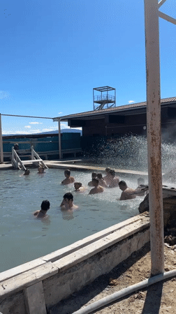 Adults enjoy sunny day swimming in Zhemchug pool