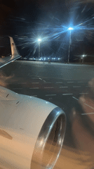 Passenger captures nighttime airport views from plane window in Ufa