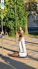Street musicians perform in decorated Zelenogradsk pedestrian zone