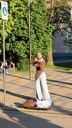 Street musicians perform in decorated Zelenogradsk pedestrian zone