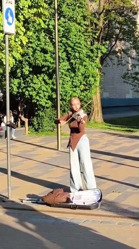 Street musicians perform in decorated Zelenogradsk pedestrian zone