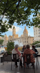 Women gather at Valencia cafe on palm-lined street