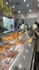 Italian bakery showcases decorated cakes and pastries morning operation