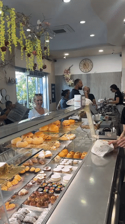Italian bakery showcases decorated cakes and pastries morning operation