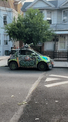 Wildly decorated Smart car parked on a New York residential street