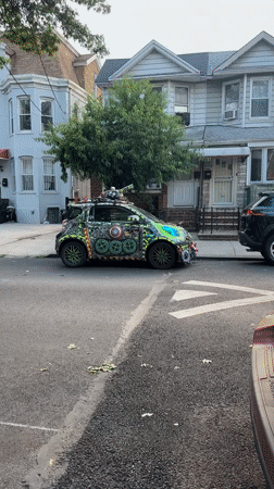 Wildly decorated Smart car parked on a New York residential street