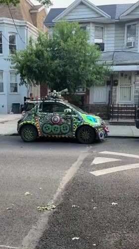 Wildly decorated Smart car parked on a New York residential street