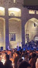 Female DJ draws large nighttime crowd to Barcelona courtyard concert