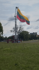 Lithuanian flag raised high on a vehicle-mounted ladder in Klaipėda