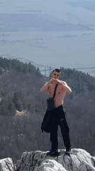 Young Adults Perform Athletic Stunts at Bulgarian Mountain Monument