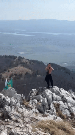 Young Adults Perform Athletic Stunts at Bulgarian Mountain Monument