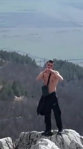 Young Adults Perform Athletic Stunts at Bulgarian Mountain Monument