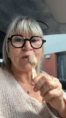Woman shares ice cream stick with cat in France