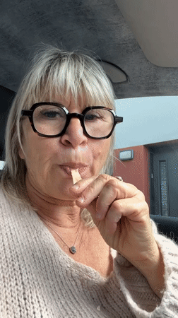 Woman shares ice cream stick with cat in France
