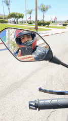 Motorcyclist takes mirror selfie on Meknes street