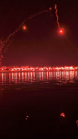 Fireworks and flares illuminate Rijeka's harbor at night