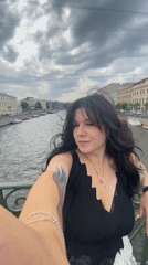 Selfies on a Saint Petersburg canal bridge, summer morning
