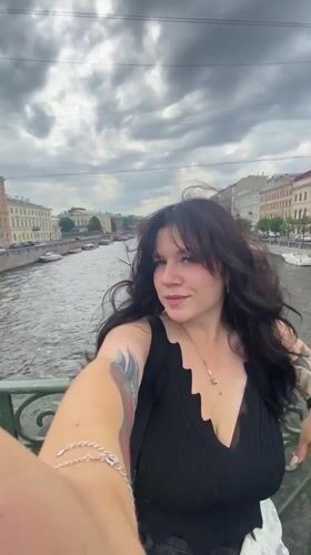 Selfies on a Saint Petersburg canal bridge, summer morning