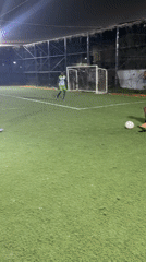Nighttime soccer match played on enclosed turf field in Nigeria