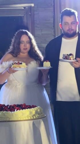 Wedding cake cutting and sparklers at a summer night celebration