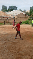 Pickup soccer on a rocky dirt field in Jos, Nigeria