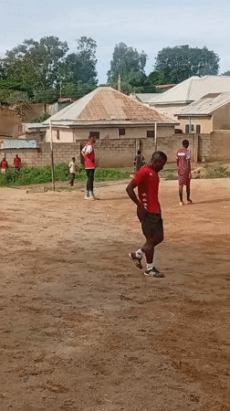 Pickup soccer on a rocky dirt field in Jos, Nigeria