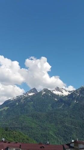 Snow-capped peaks and artificial flowers in Krasnaya Polyana
