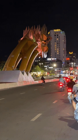 Nighttime ride past Đà Nẵng's glowing Dragon Bridge sculpture