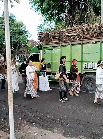 Traditional street procession winds through Sragen with flags and offerings