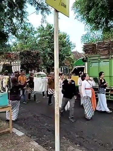 Traditional street procession winds through Sragen with flags and offerings