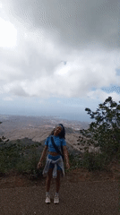 Woman photographed at scenic Las Piedras overlook above coastal city