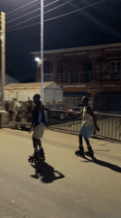 Young people inline skating at night in Jos, Nigeria