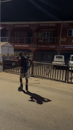 Young people inline skating at night in Jos, Nigeria